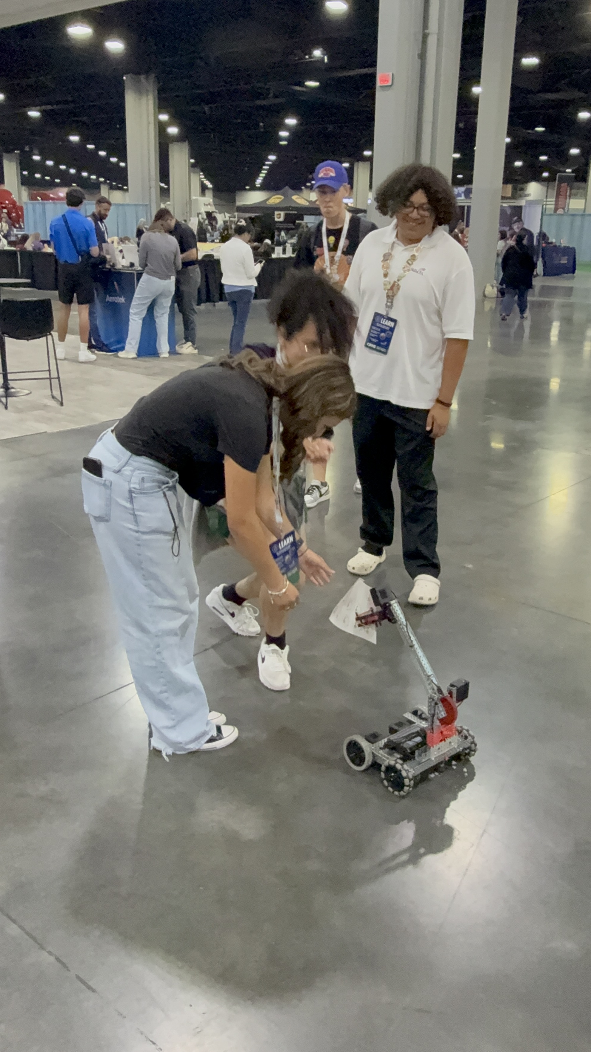 Students testing a small robotics build on the SkillsUSA expo floor.